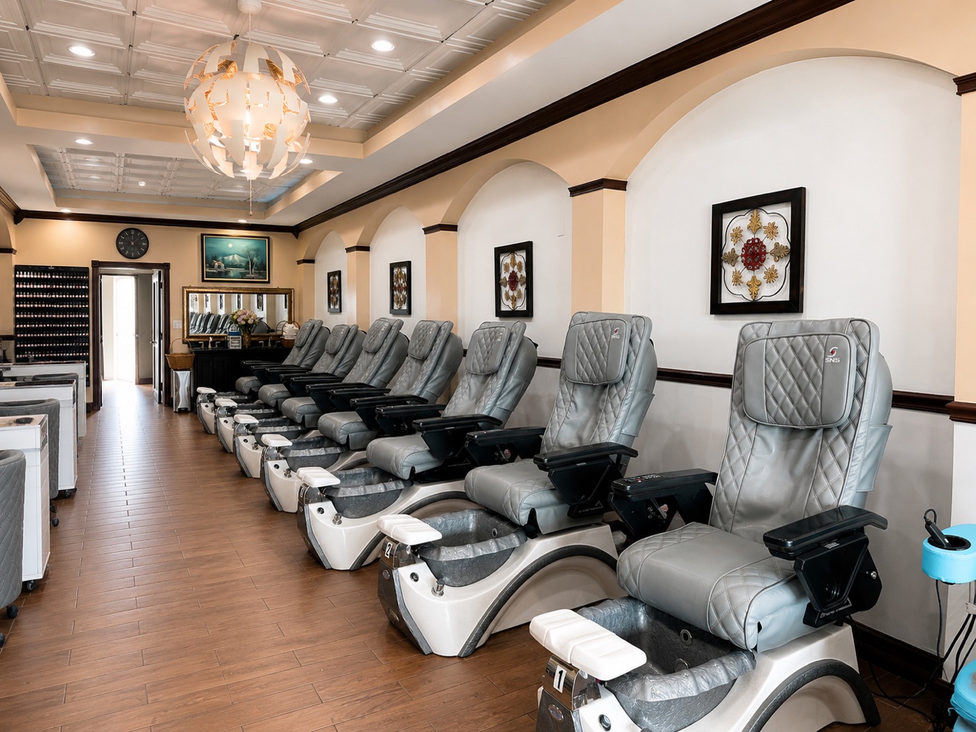 Massage pedicure chairs down the length of the salon